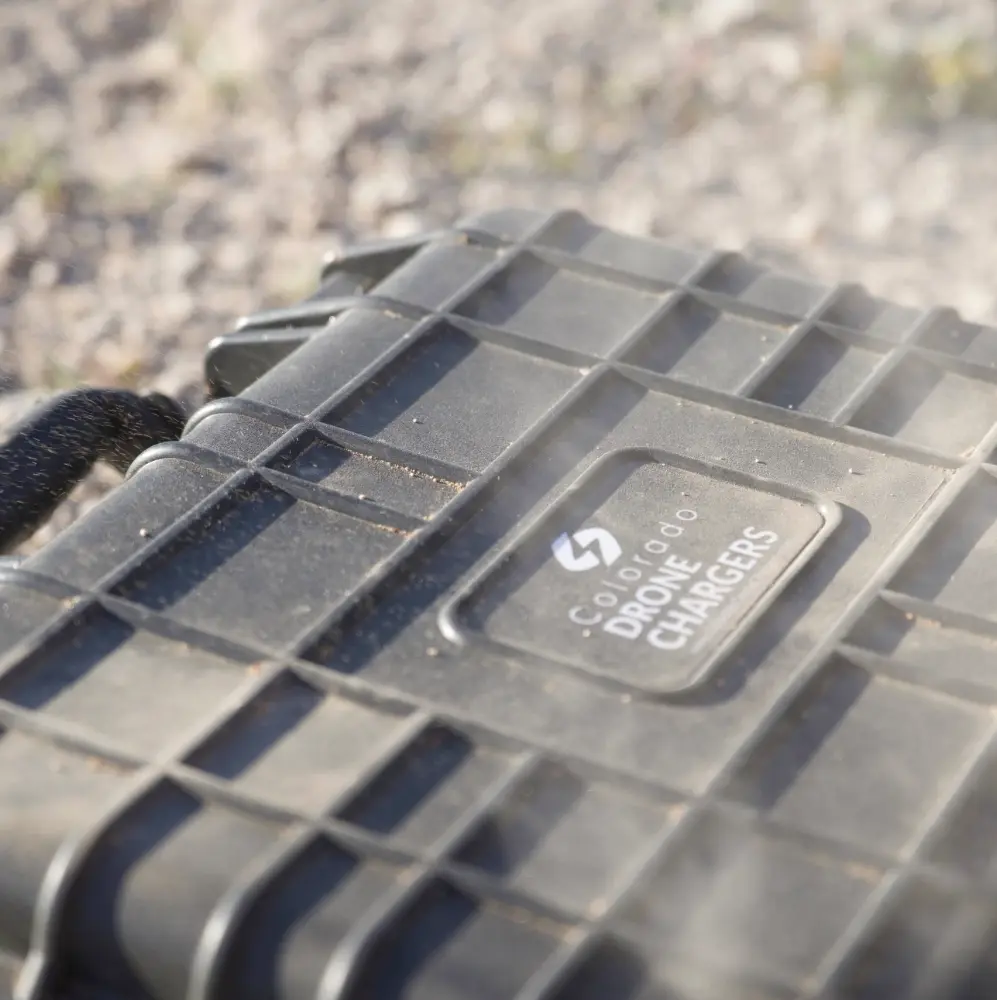 The hard, rugged Colorado Drone Chargers case in a dusty environment.